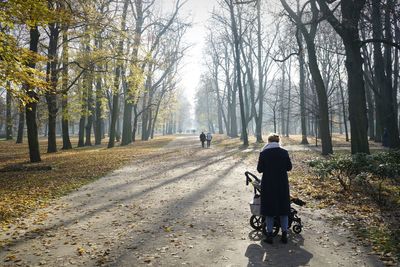 Rear view of people walking on road in winter