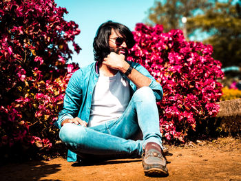 Full length of woman sitting on flower