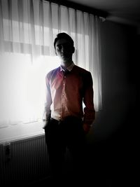 Full length of man standing in corridor