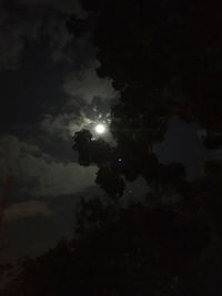 Low angle view of silhouette moon against sky at night