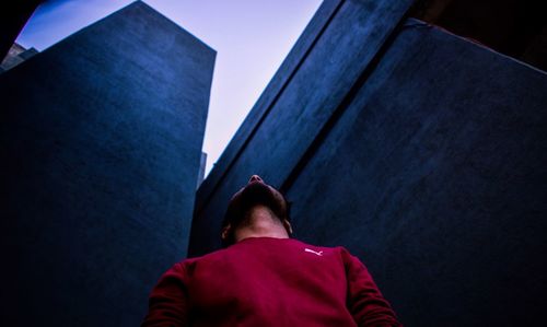 Rear view of man standing against wall