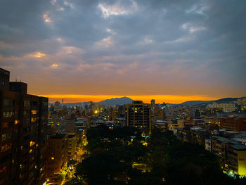 High angle view of illuminated buildings against sky during sunset