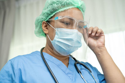 Midsection of female doctor wearing mask