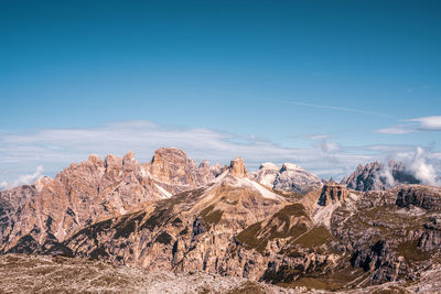 Scenic view of snowcapped mountains against blue sky