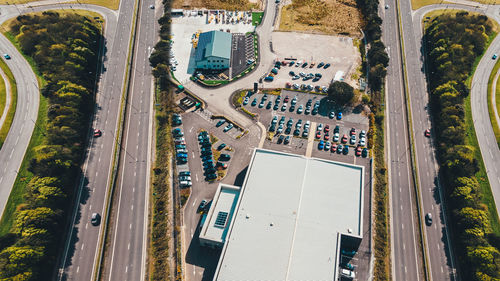 Aerial view of shopping mall parking lot with highway nearby