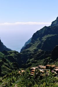 Scenic view of sea and mountains against sky