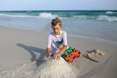 Boy making sandcastle at beach