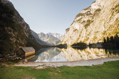 Scenic view of lake and mountains against clear sky