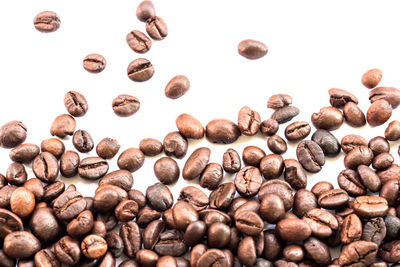 Close-up of coffee beans against white background