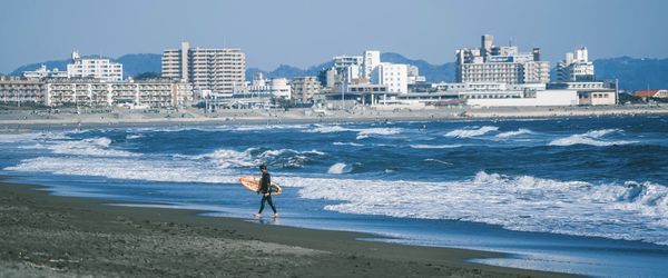 Man on beach by sea