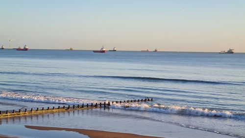 Scenic view of sea against clear sky during sunset