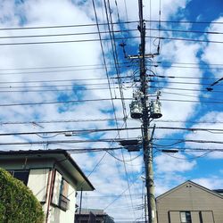 Low angle view of electricity pylon against sky