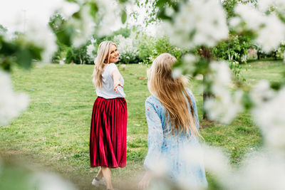 Woman standing by plants on field