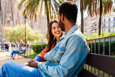 Side view of young woman using mobile phone