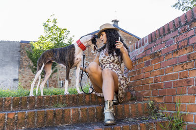 Low section of person with dog on wall