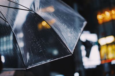 Close-up of wet car windshield in city during rainy season