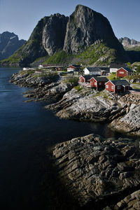 Scenic view of buildings and mountains against sky