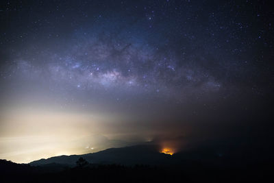 Silhouette mountain against sky at night
