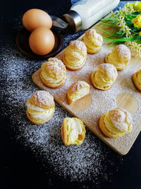 Cream stuffed breads on cutting board in kitchen