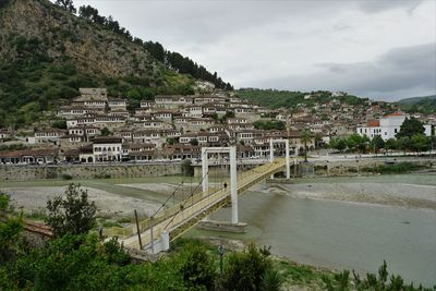 High angle view of townscape by river against sky