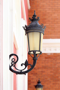 Close-up of street light against building