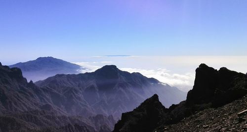 Scenic view of mountains against clear blue sky