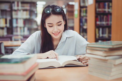 Portrait of young woman reading book