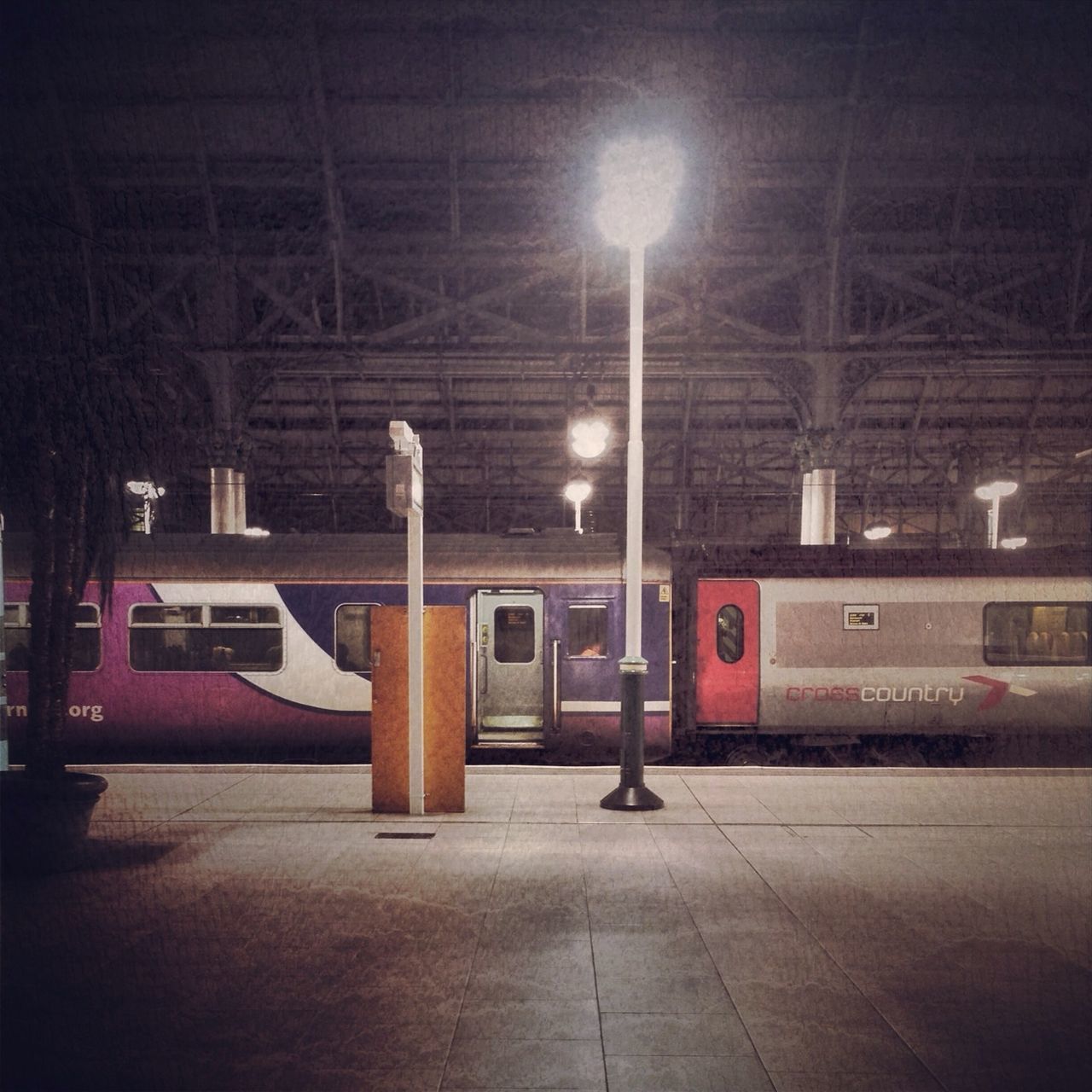 transportation, illuminated, mode of transport, public transportation, night, railroad station platform, train - vehicle, railroad station, rail transportation, land vehicle, travel, communication, indoors, railroad track, road, no people, guidance, text, passenger train, car