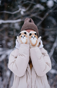 Caucasian woman in white warm jacket standing on snow. winter fashion. cute mittens