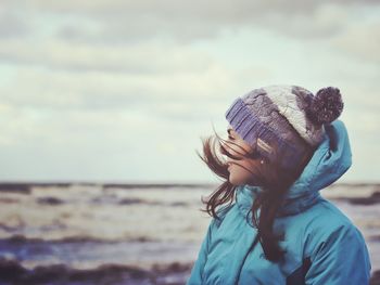 Portrait of women wearing hat at beach against sky