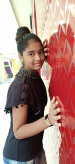 Portrait of cute girl standing at home