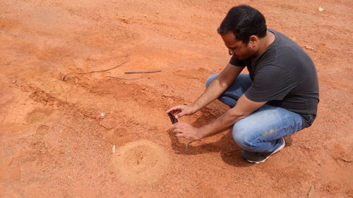 High angle view of man photographing on field