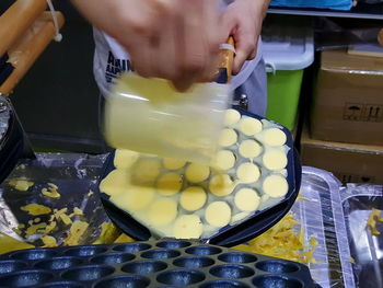 Close-up of man preparing food in kitchen