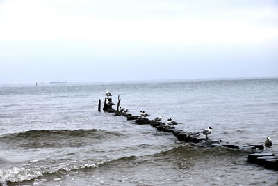 People on sea against sky