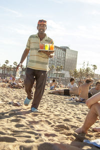 People on beach against sky