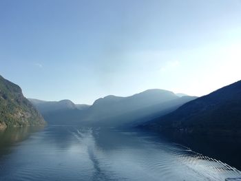 Scenic view of lake and mountains against clear sky