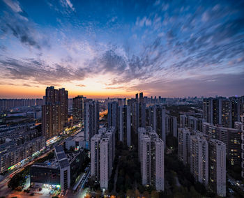 High angle view of buildings against sky during sunset