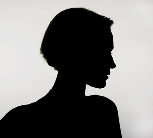 Close-up portrait of silhouette man against white background