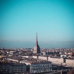 Buildings in city against clear sky
