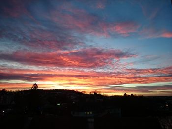 Dramatic sky over silhouette landscape