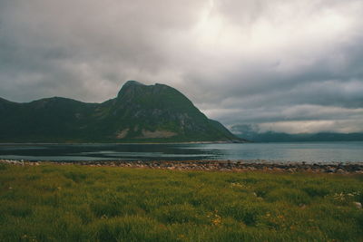 Scenic view of land and mountains against sky