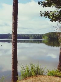 Scenic view of lake against cloudy sky