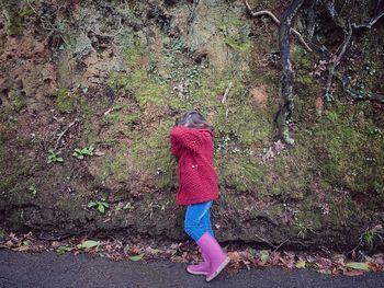 Full length rear view of woman walking in forest