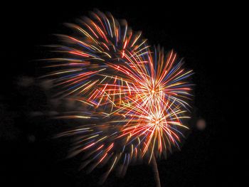 Low angle view of firework display at night