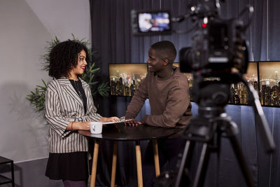 Smiling news anchors in studio