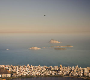 View of city by sea against sky