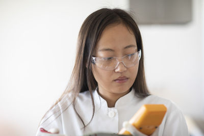 Scientist female with sample and tool in a lab