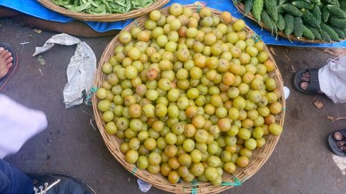 Low section of people standing by gooseberries for sale in market