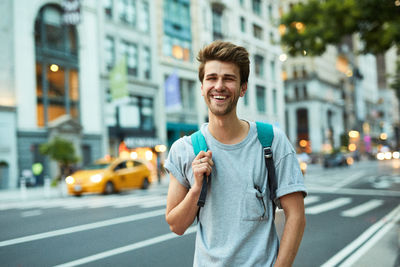 Portrait of young man in city