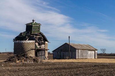 Barn on field against sky